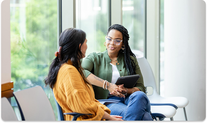 Healthcare consultation between two women in a bright, modern office setting